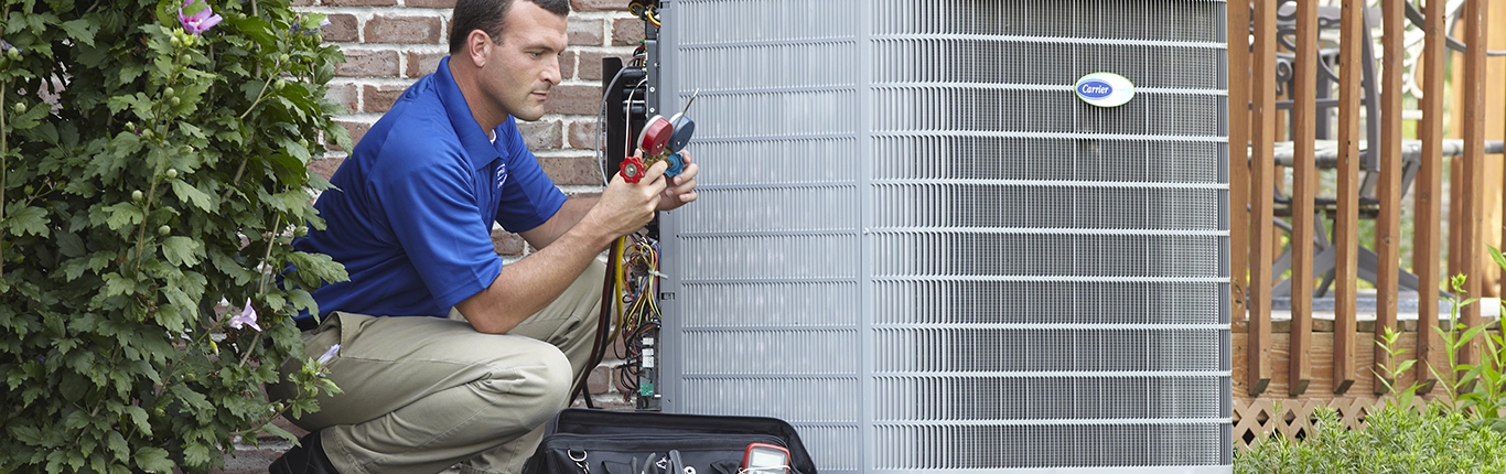 Heating and Cooling-HVAC service tech repairing an air conditioner